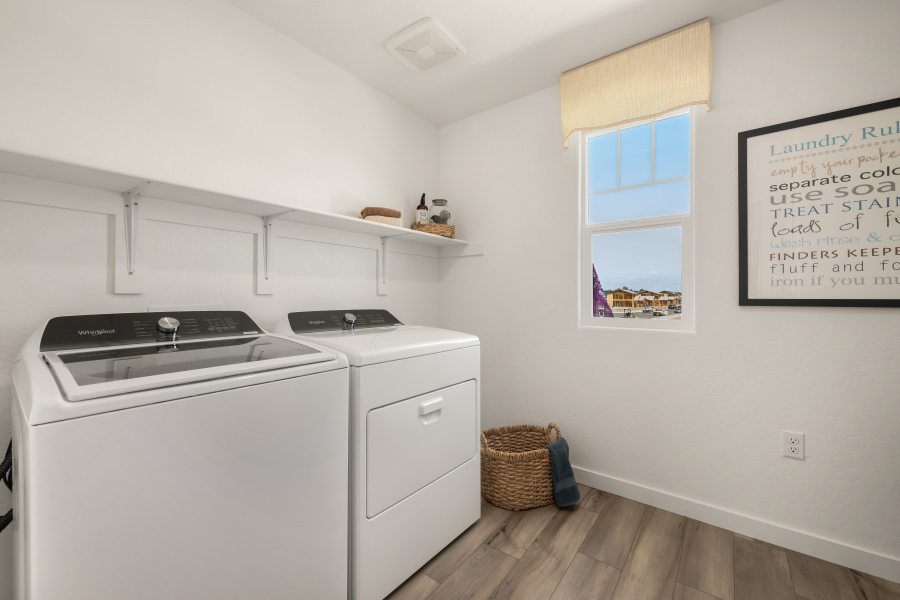 A kitchen with a washer and dryer.