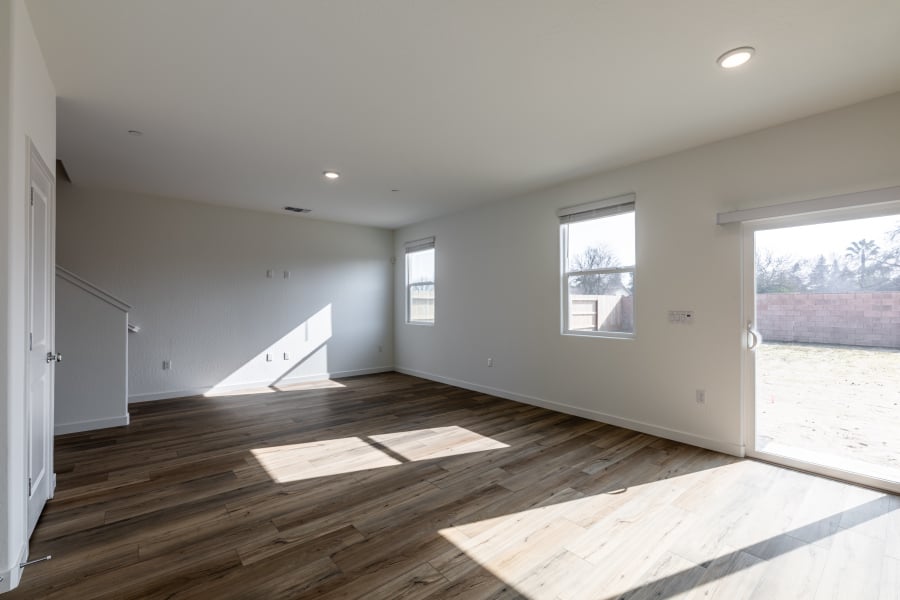 A room with a wood floor and windows.