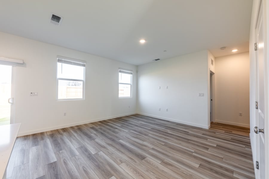 A room with a wood floor and windows.
