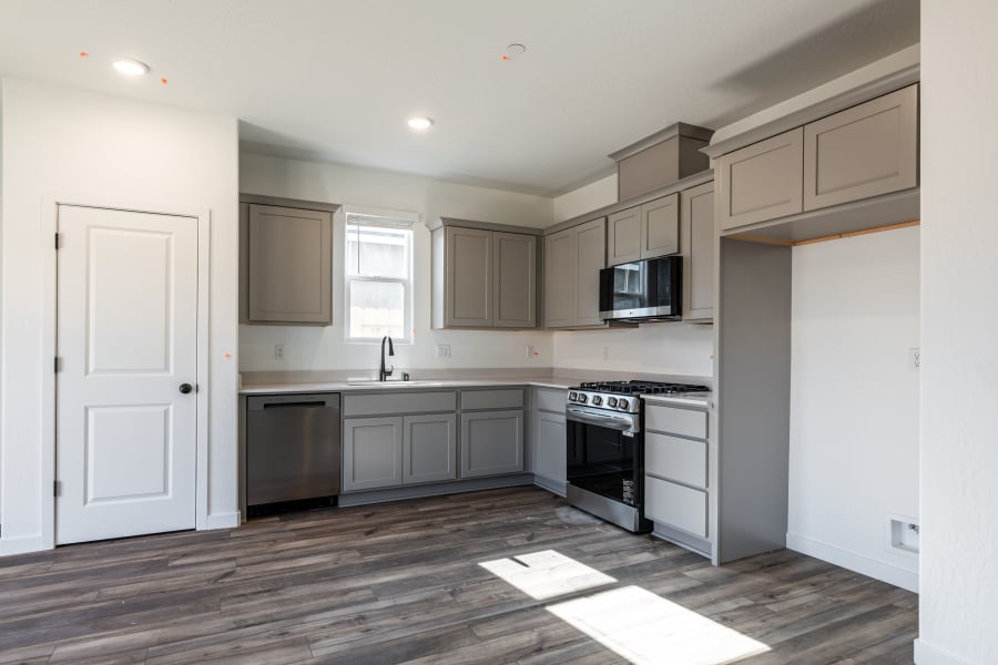 A kitchen with white cabinets.