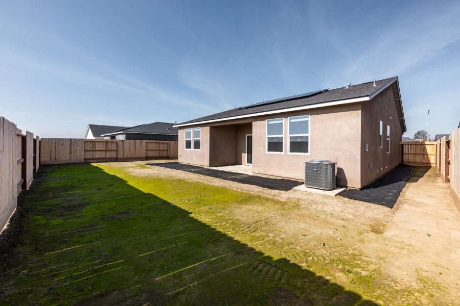 A house with a fence and grass.