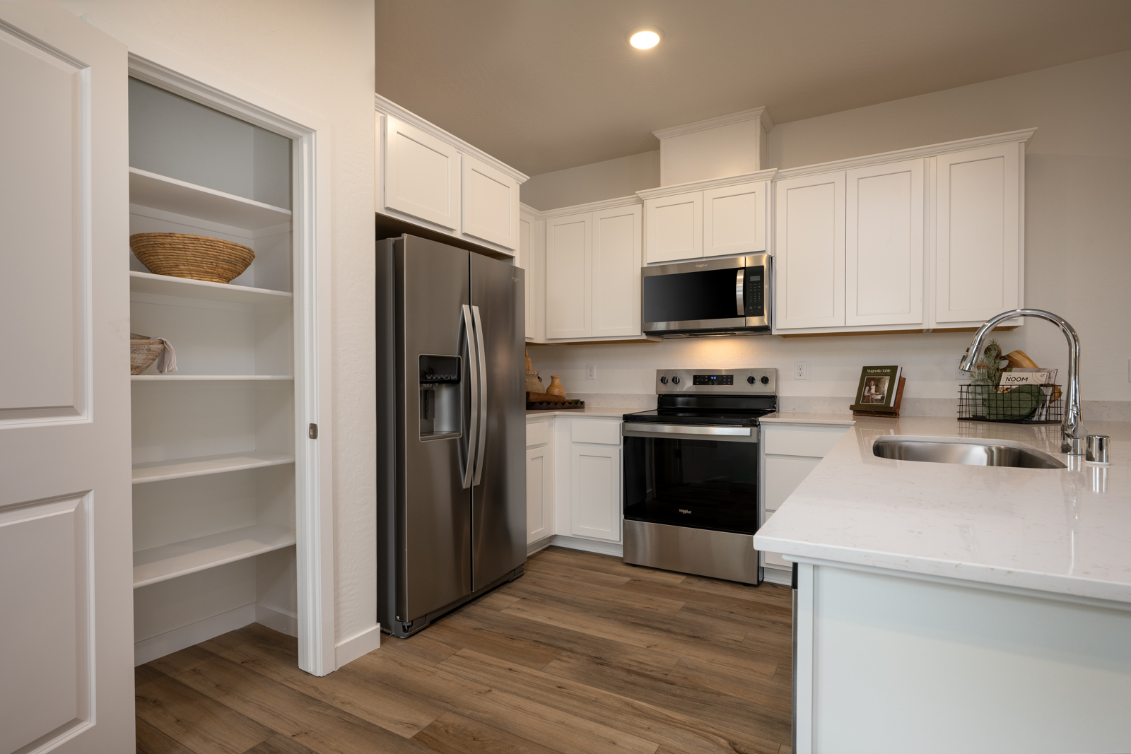 A kitchen with white cabinets.