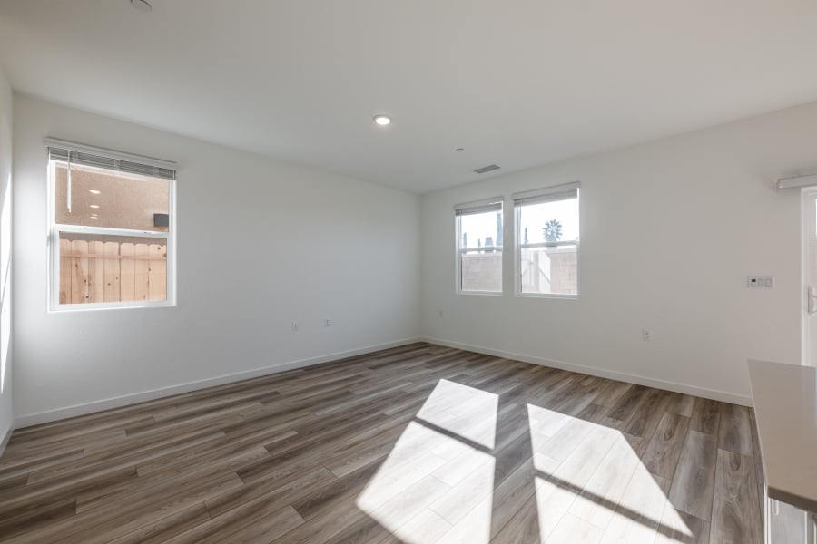 A room with windows and a rug.