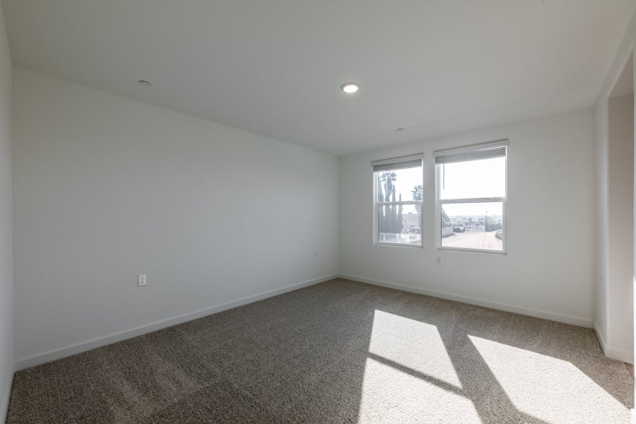 A room with a window and a carpet.