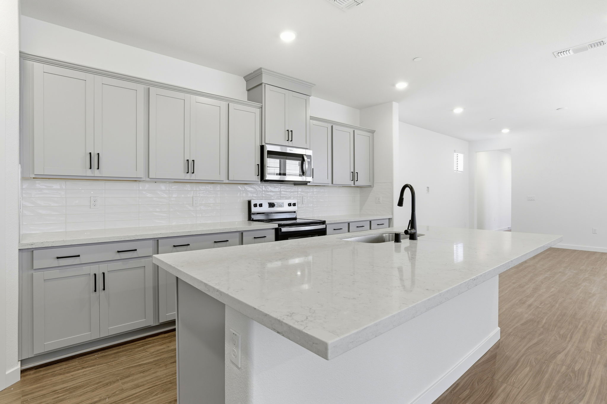A kitchen with white cabinets.