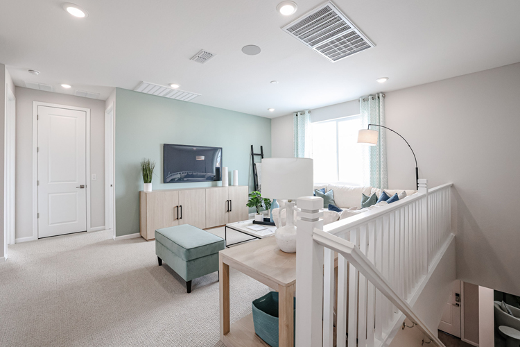 A living room with a white staircase.
