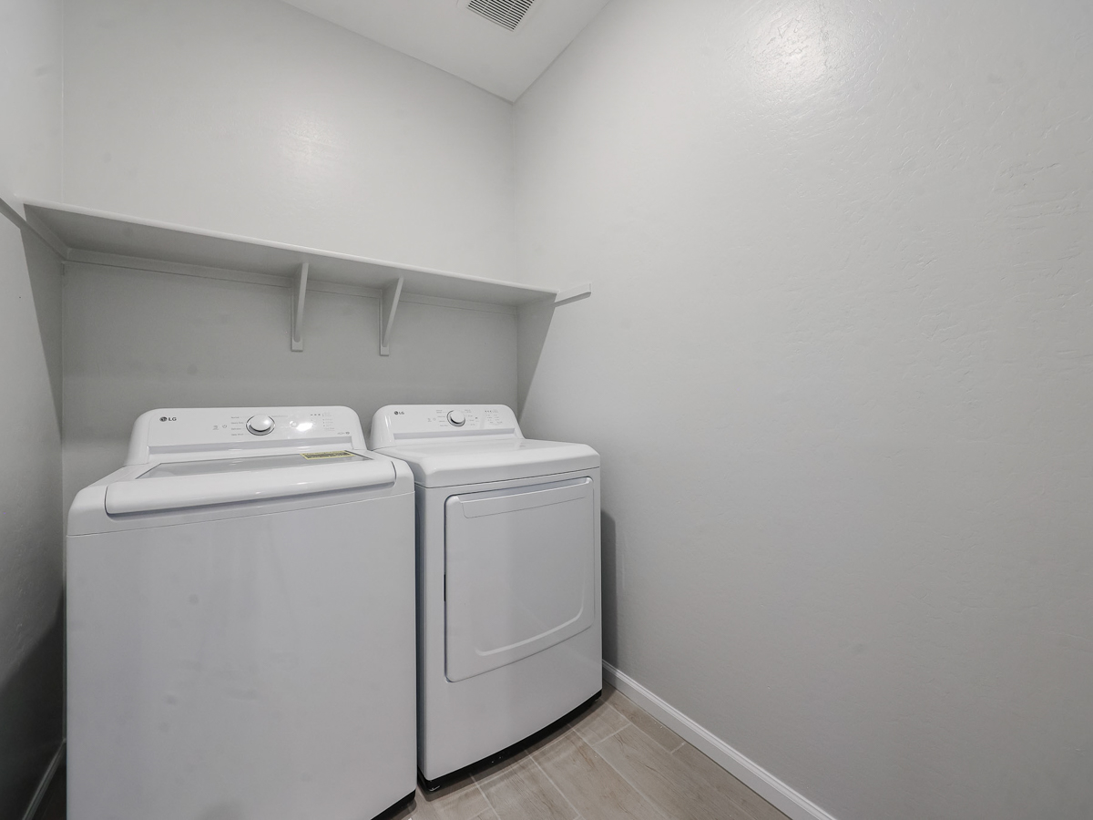 A washing machine in a room.