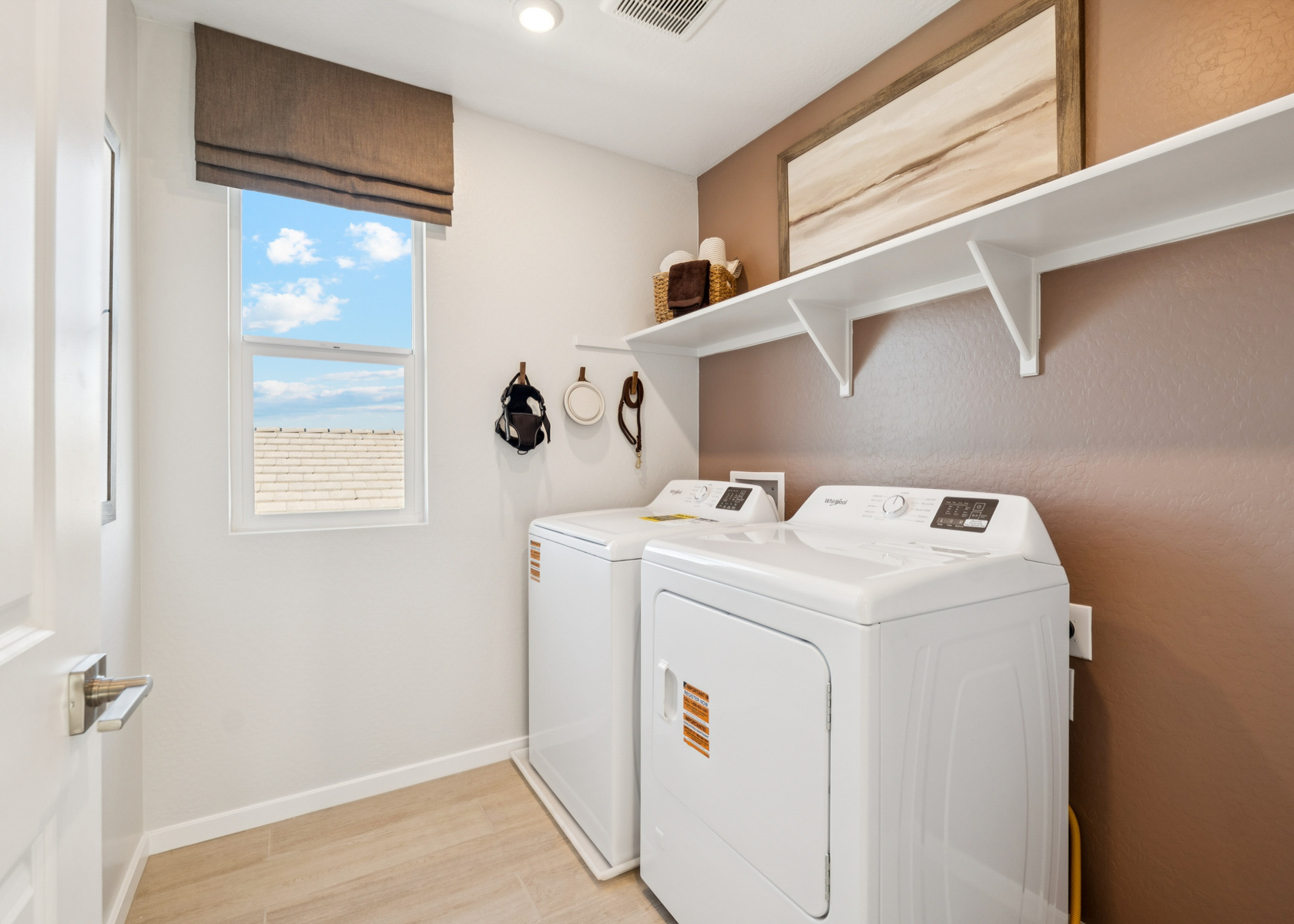 A laundry room with a white laundry machine.