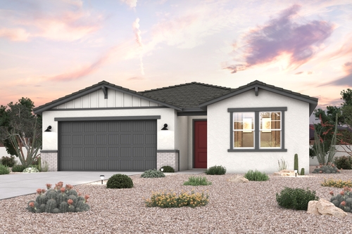 A house with a garage and bushes.