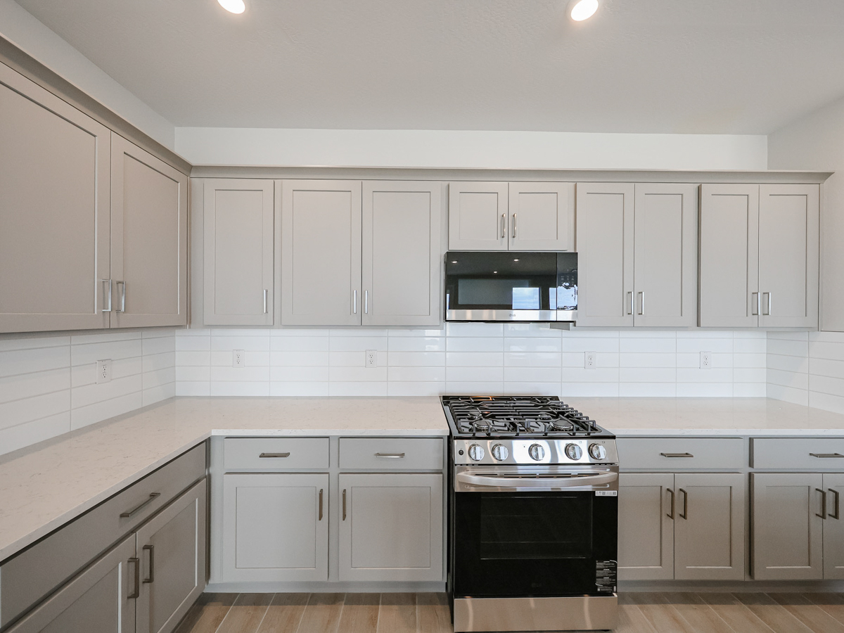 A kitchen with white cabinets.