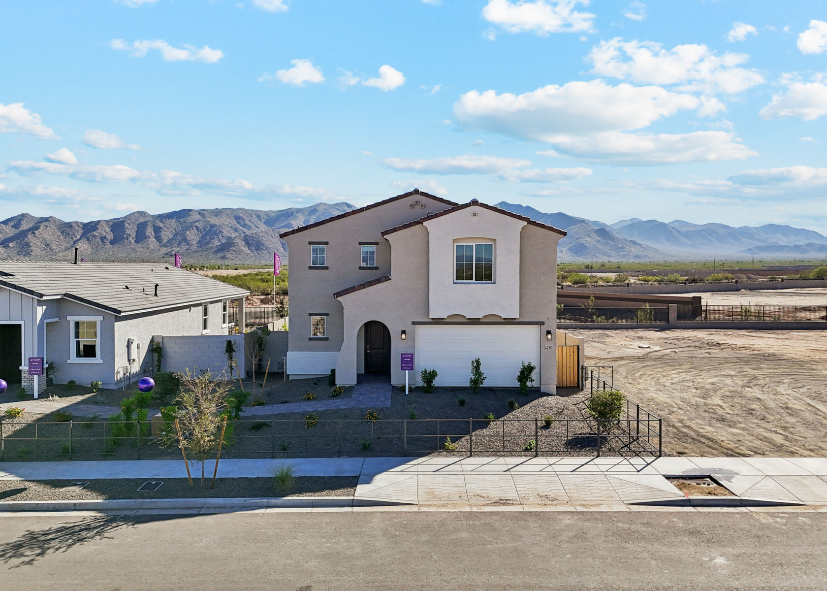 A white house with a fence around it.