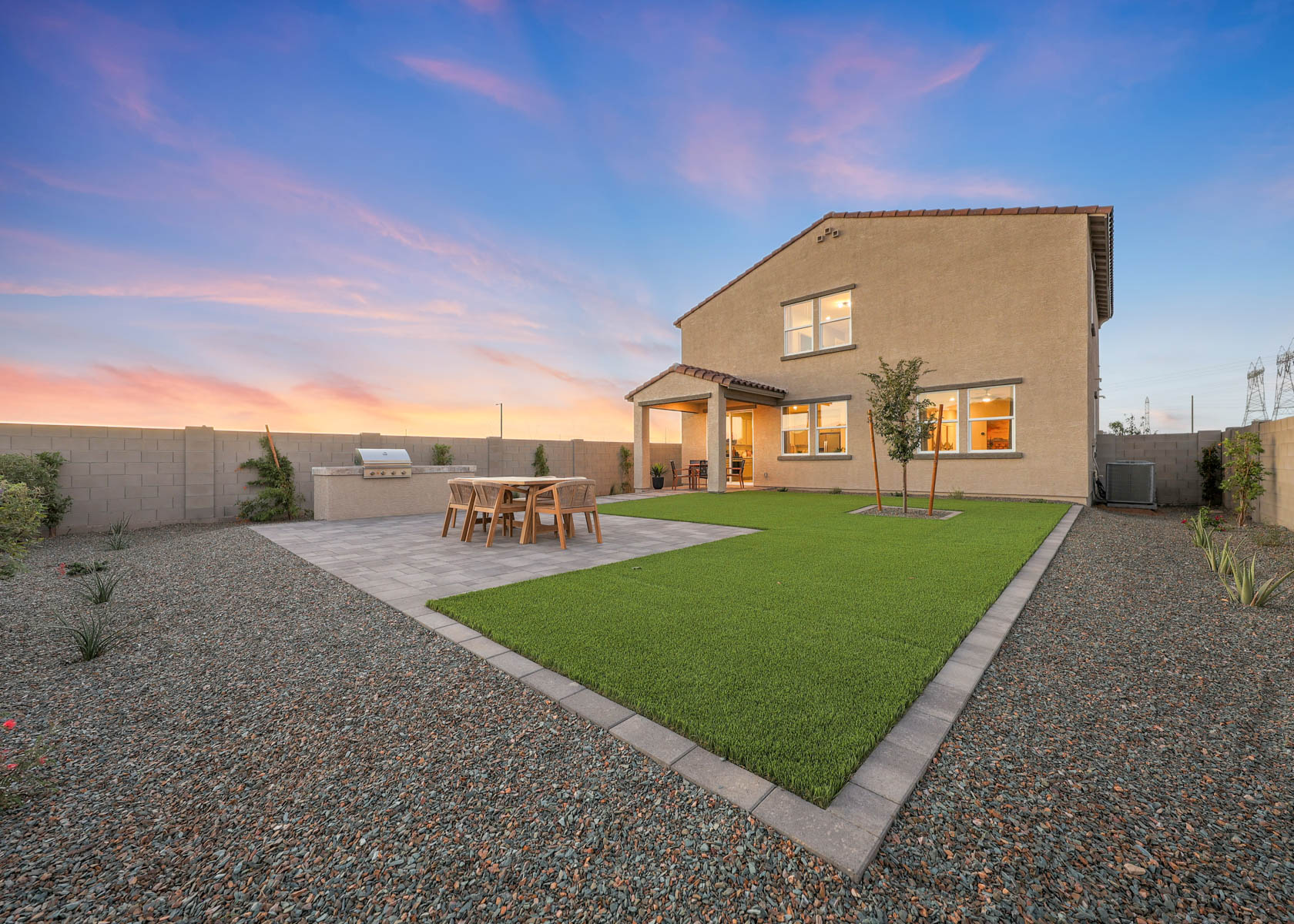 A house with a lawn and chairs.