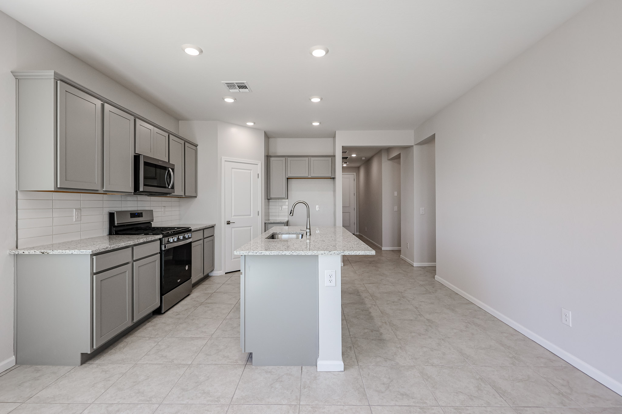 A kitchen with white cabinets.