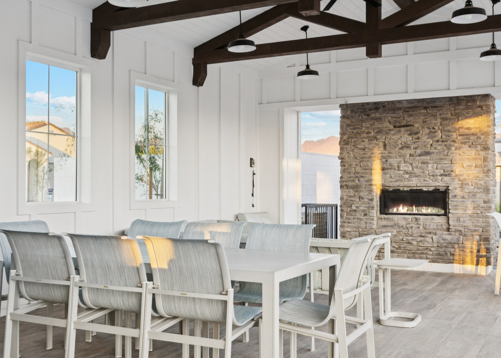 A room with a fireplace and chairs.