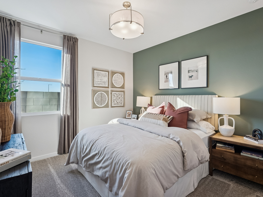 A bedroom with a bed and a window.