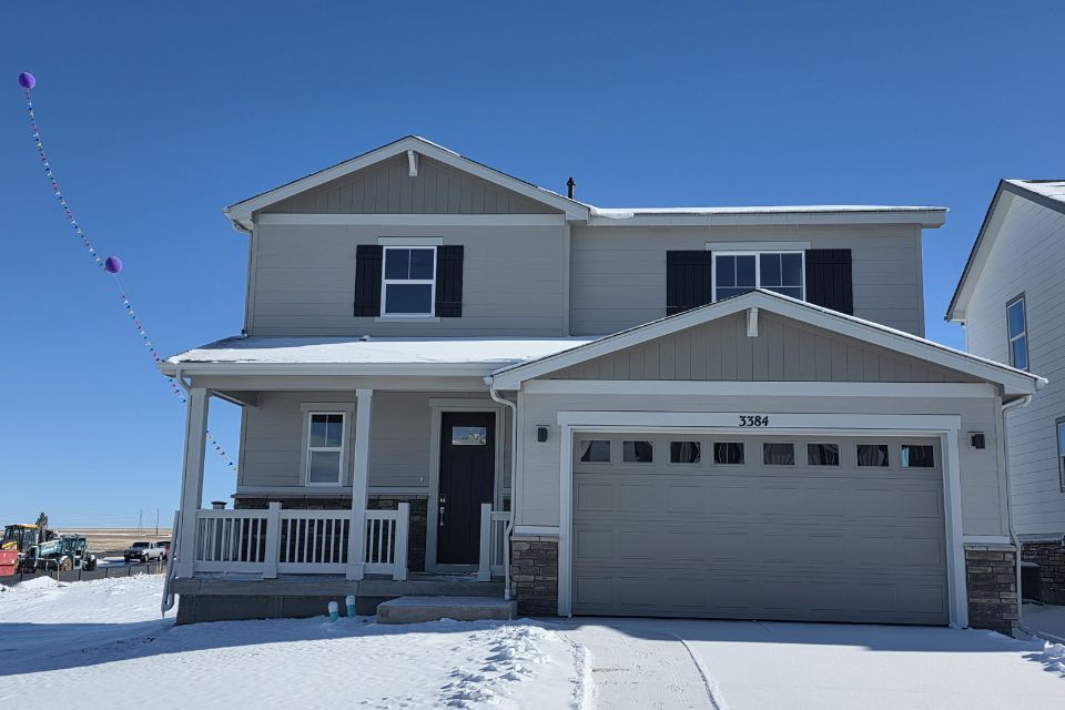 A white house with a garage.