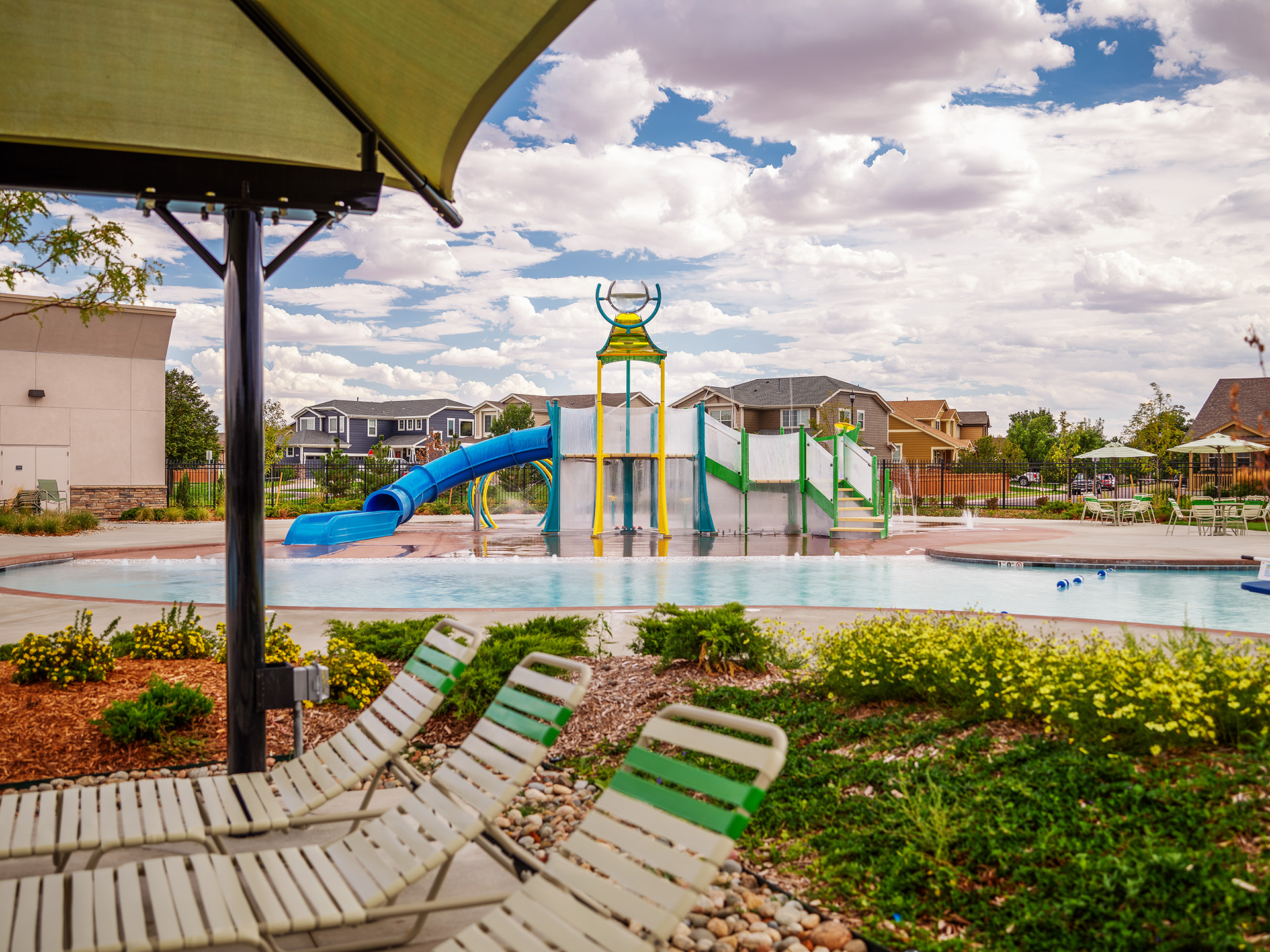 A pool with chairs and umbrella.