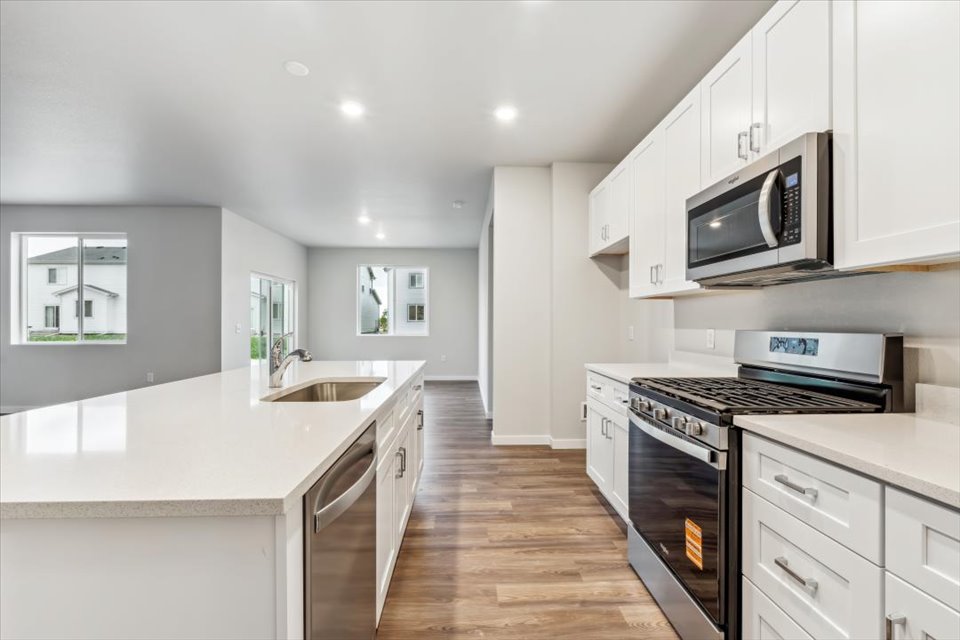 A kitchen with white cabinets.