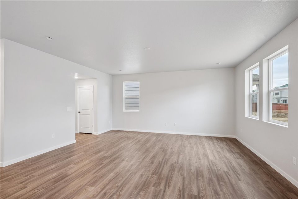 A room with a wood floor and a white door.
