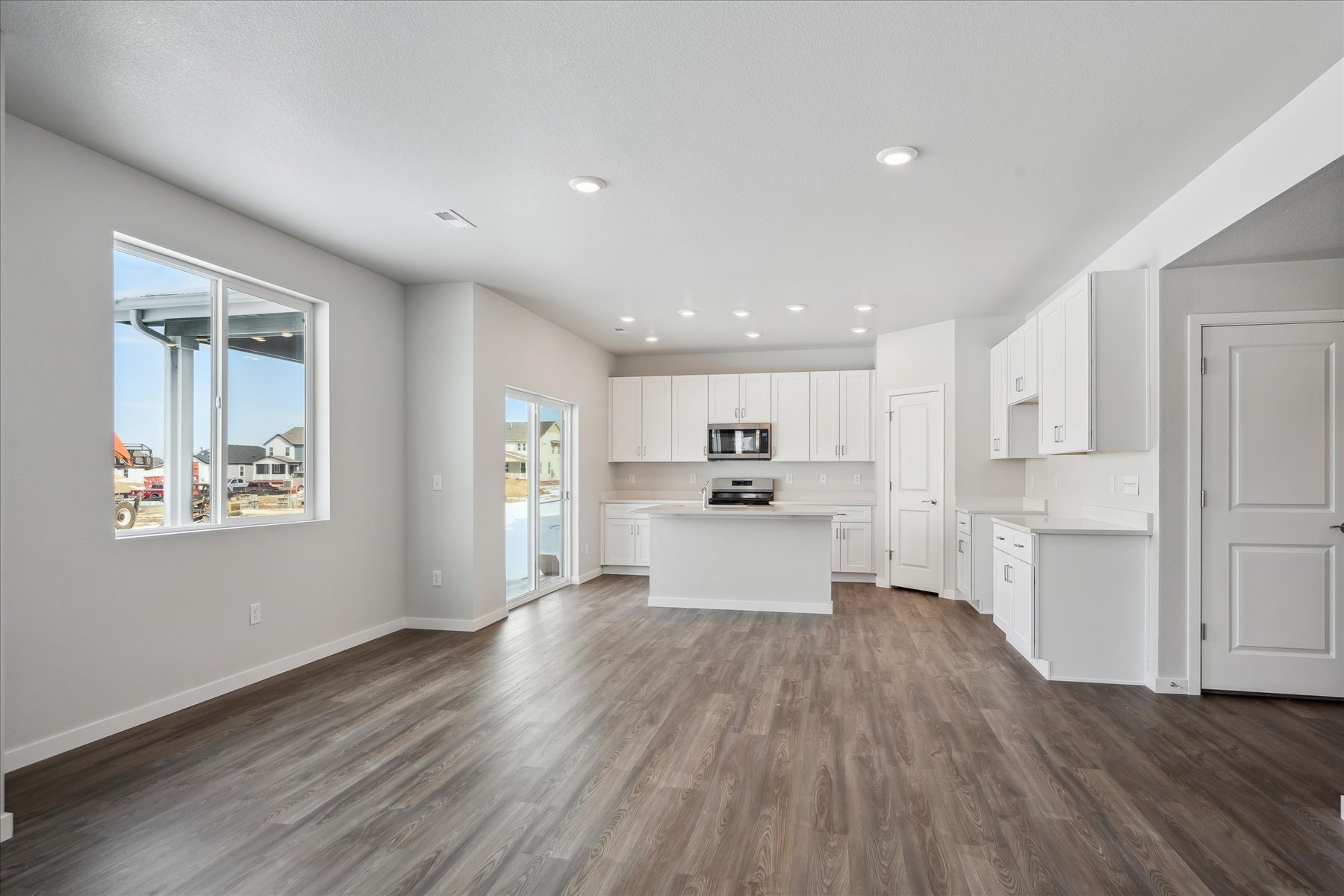 A large kitchen with white cabinets.