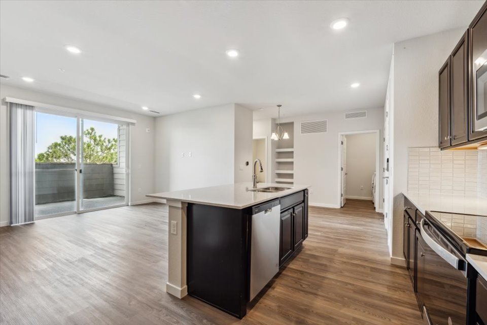 A kitchen with a wood floor.
