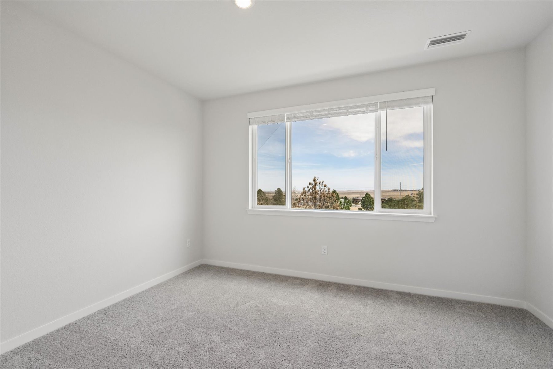 A room with a window and a view of the water.