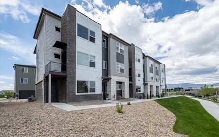 A building with a grass yard.