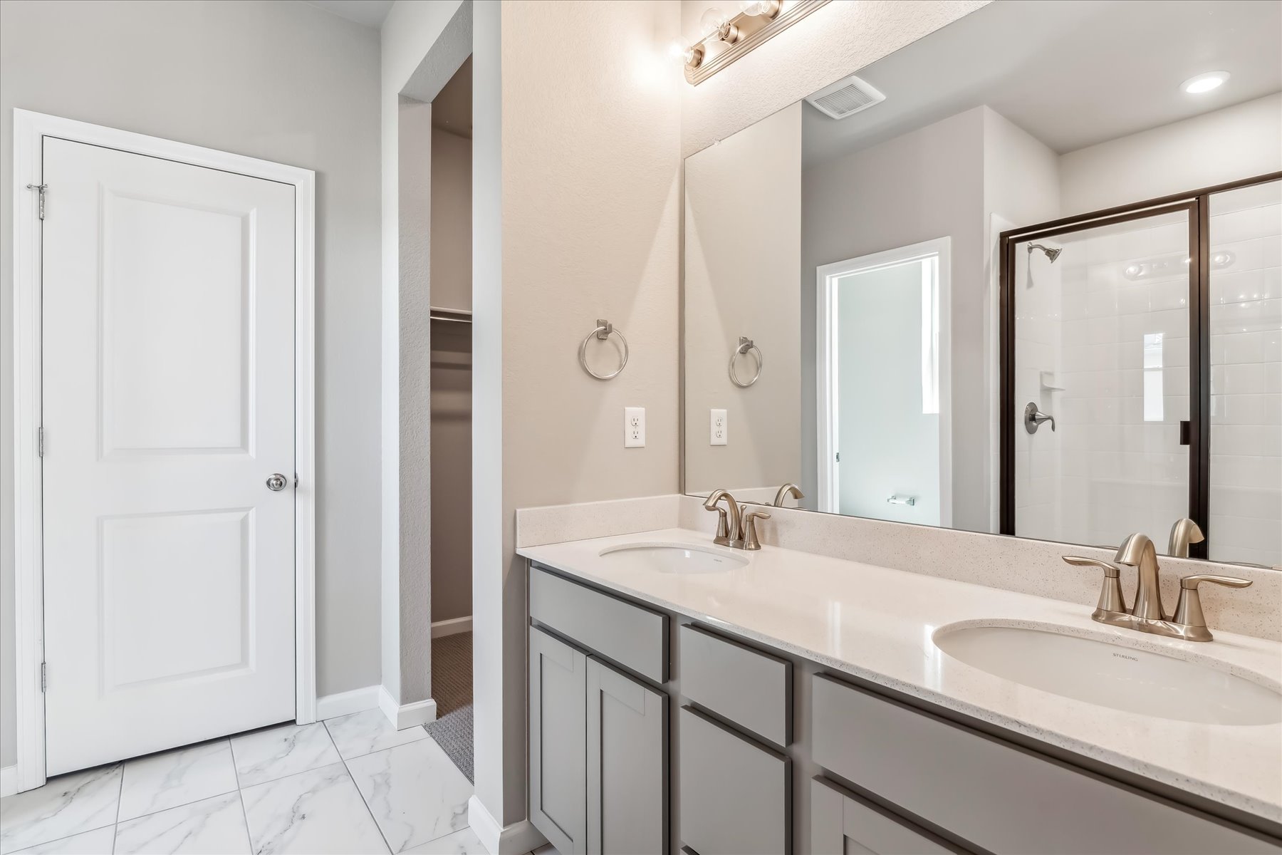 A bathroom with a large mirror.