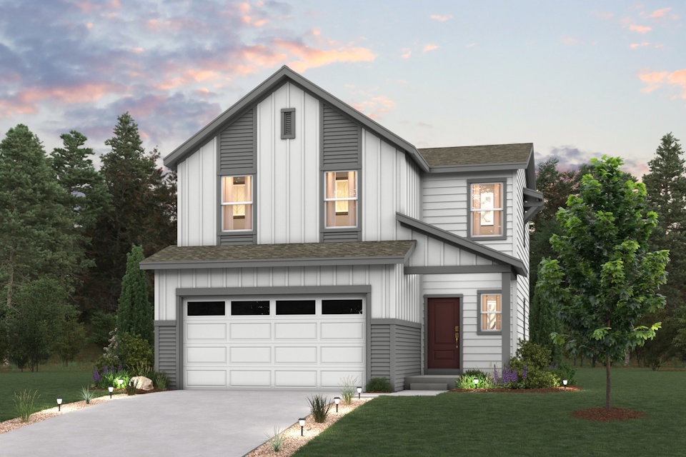 A house with a garage and trees around it.