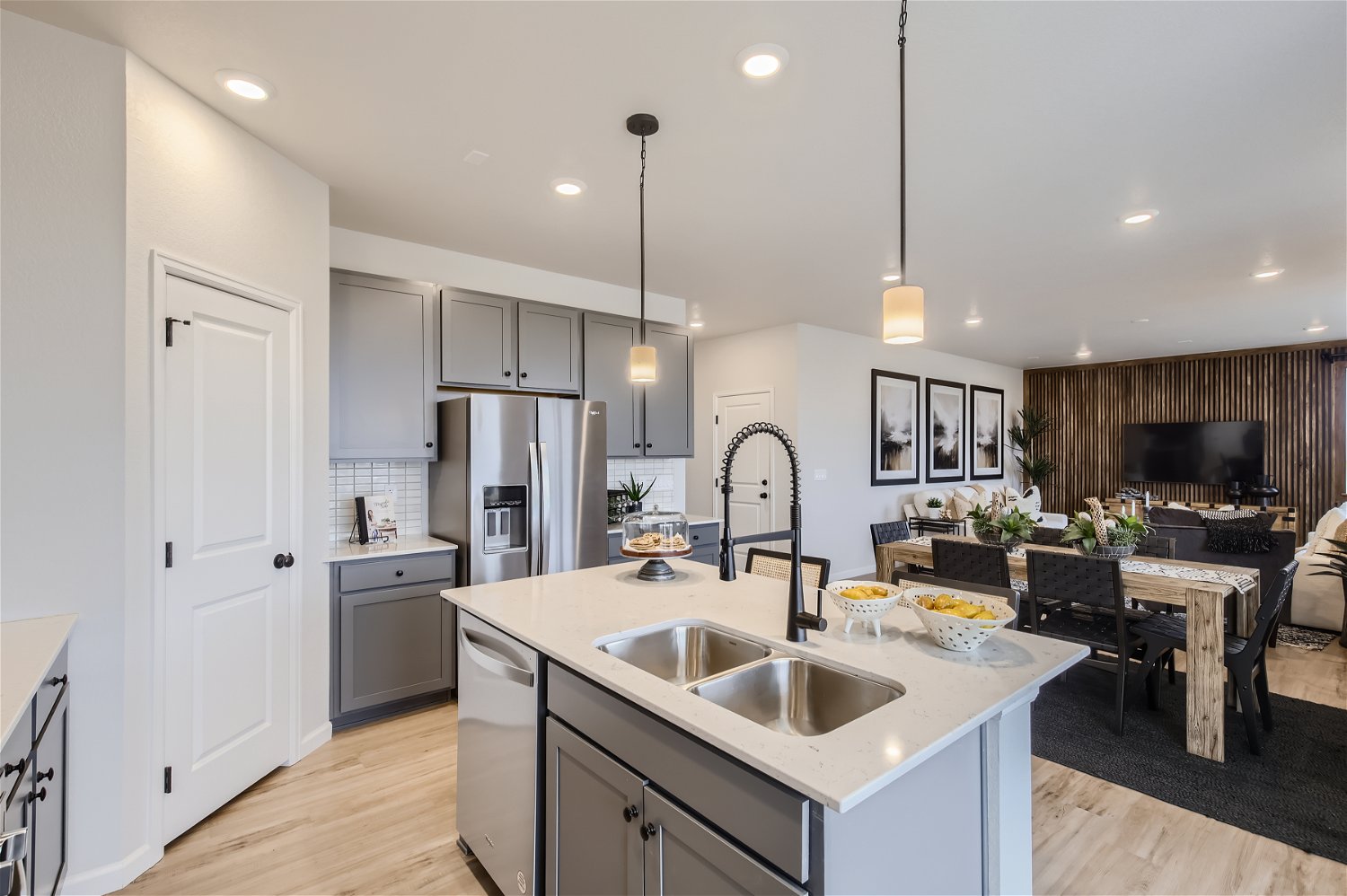 A kitchen with a bar and a dining table.