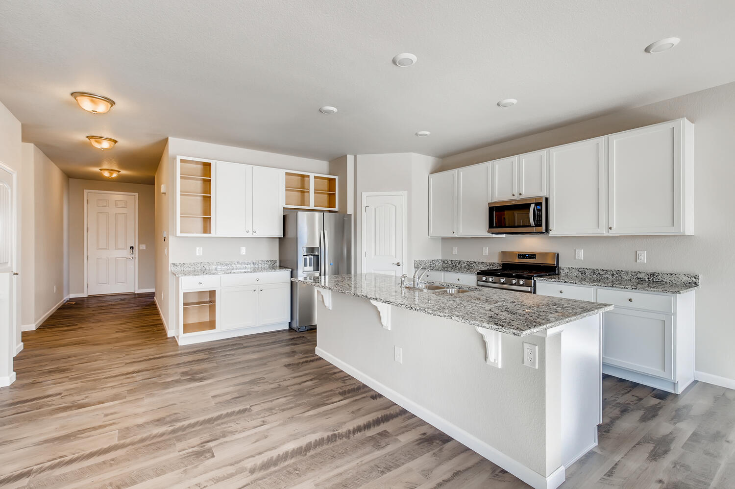 A kitchen with white cabinets.