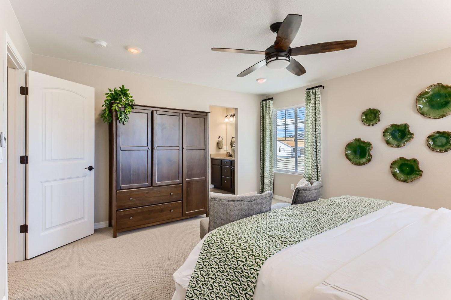 A bedroom with a bed and a fan.