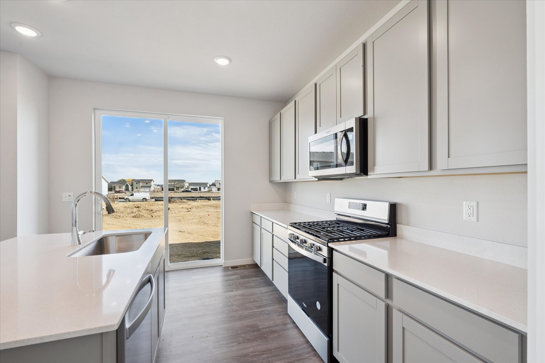 A kitchen with white cabinets.