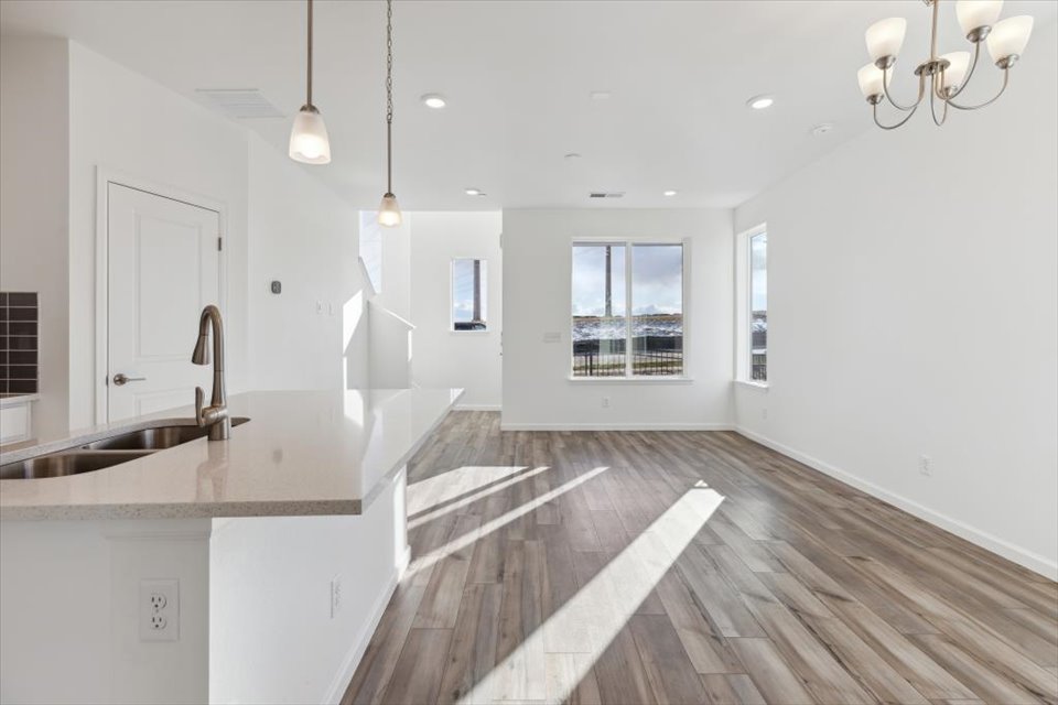 A kitchen with a wood floor.