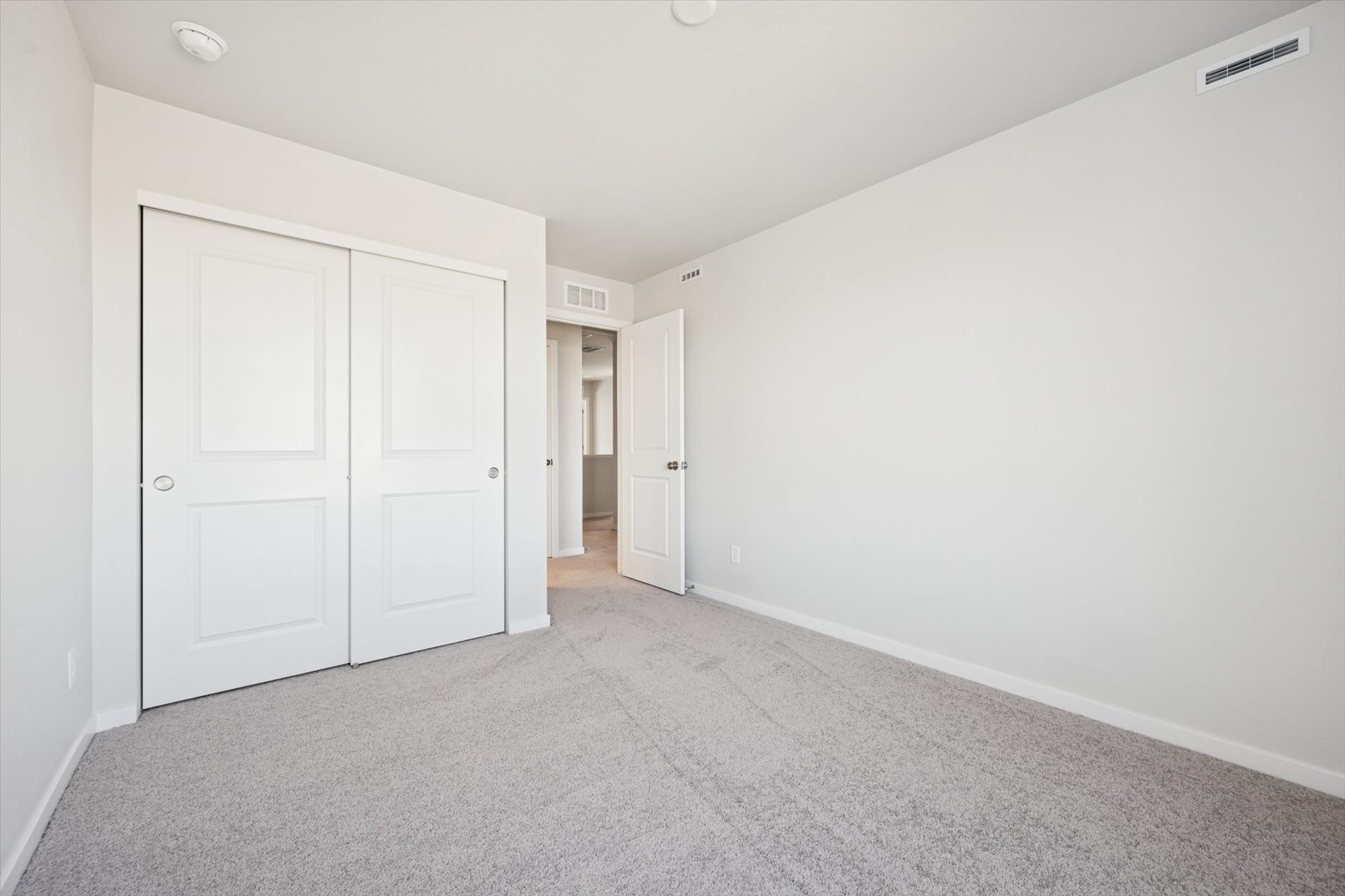 A hallway with white doors.
