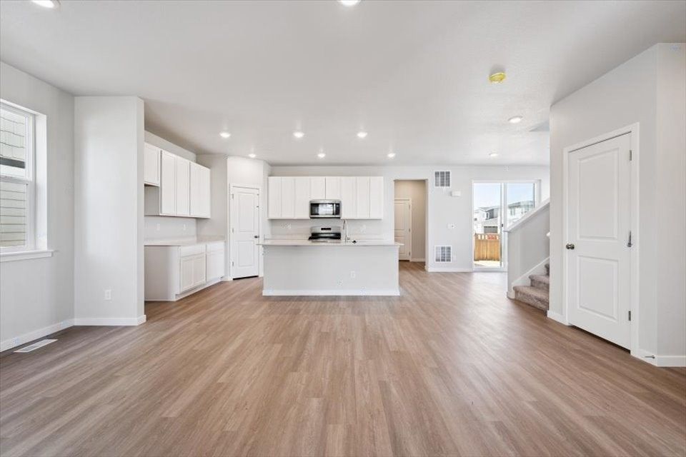 A large kitchen with white cabinets.
