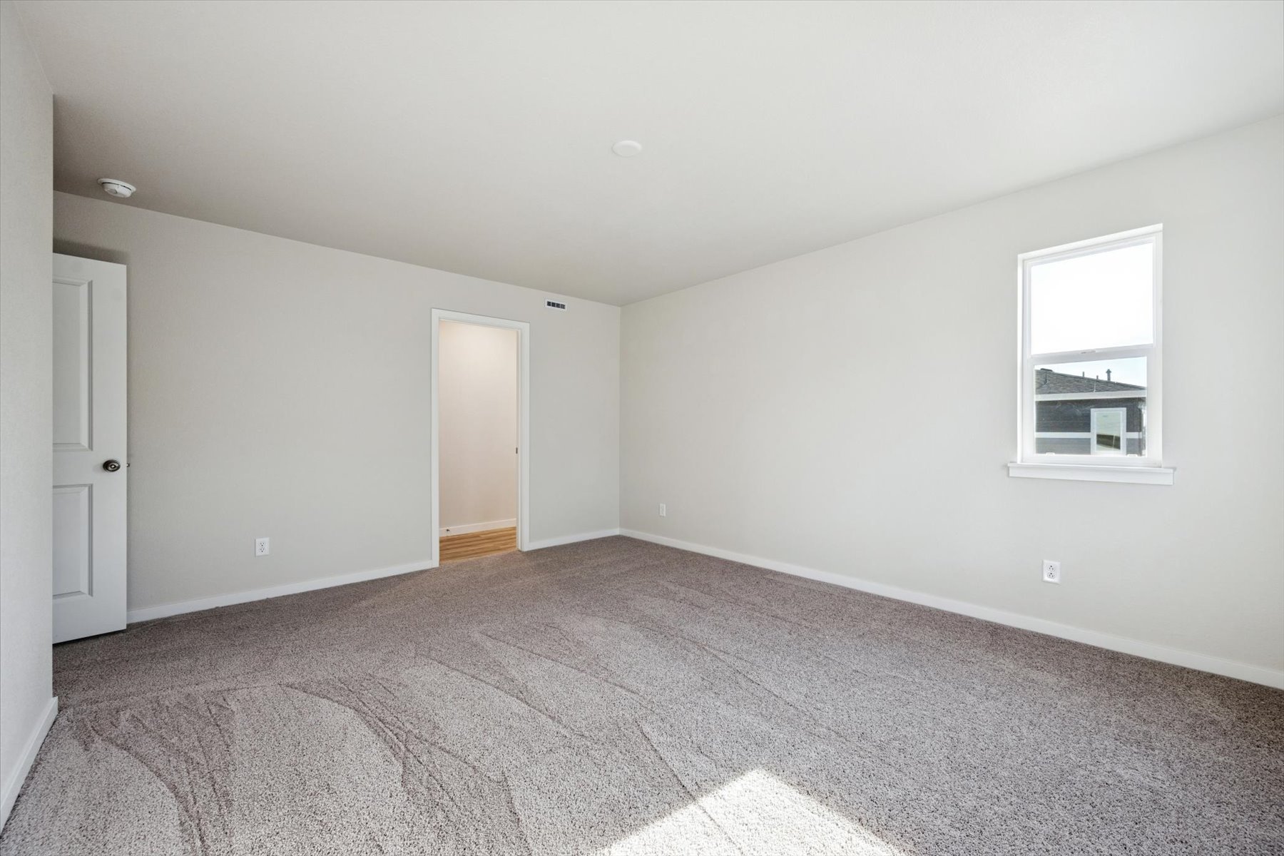 A room with a carpet and a rug.