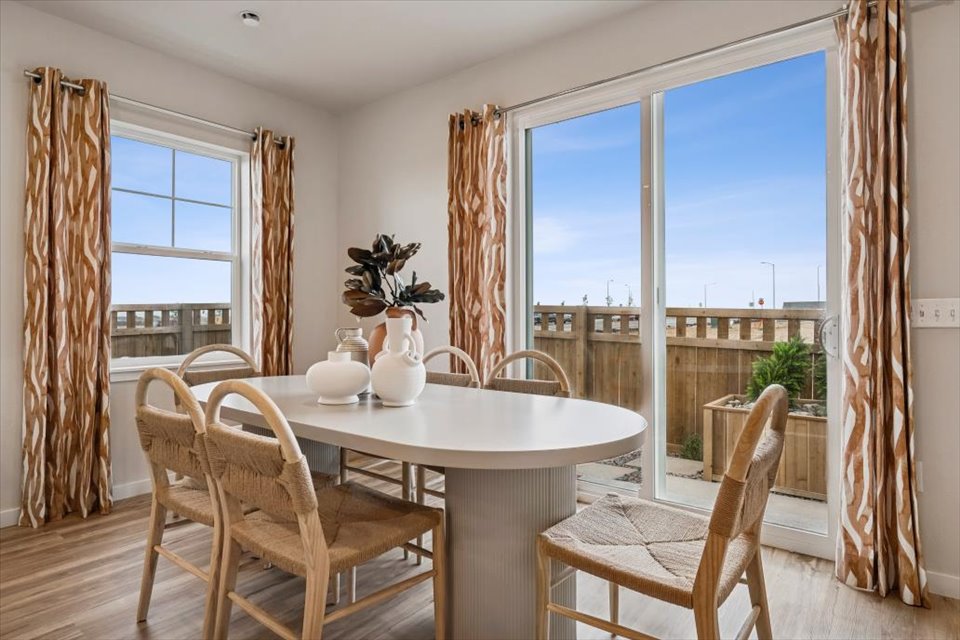 A dining table with chairs around it.