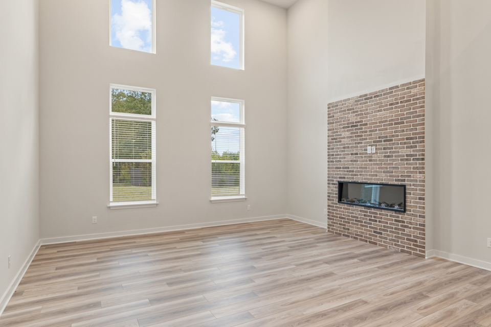 A room with a fireplace and windows.