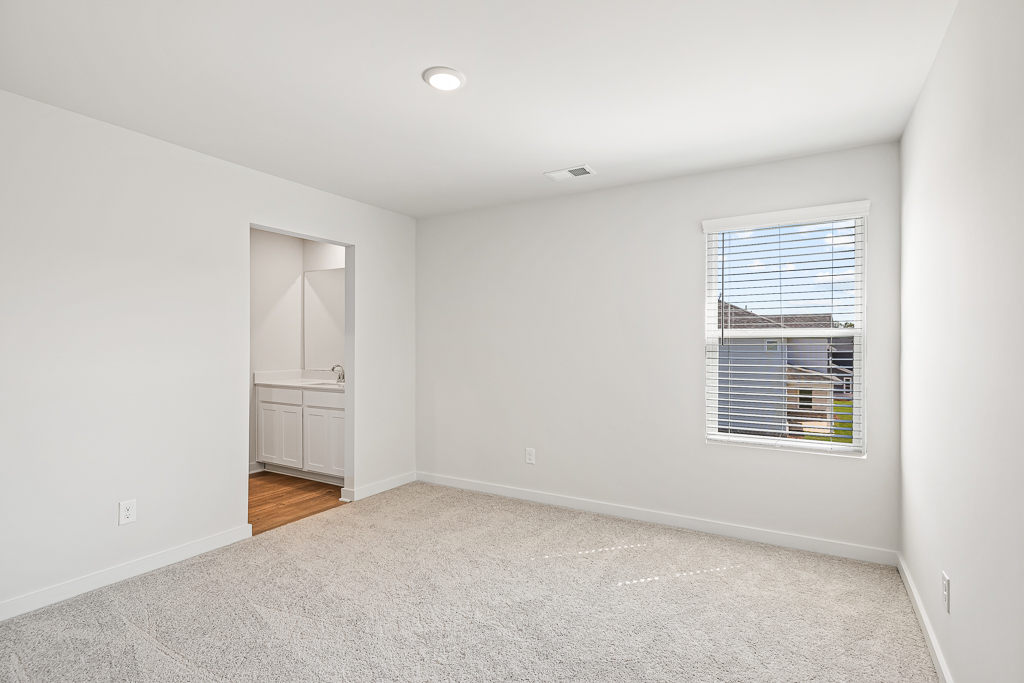 A room with a window and a carpet.
