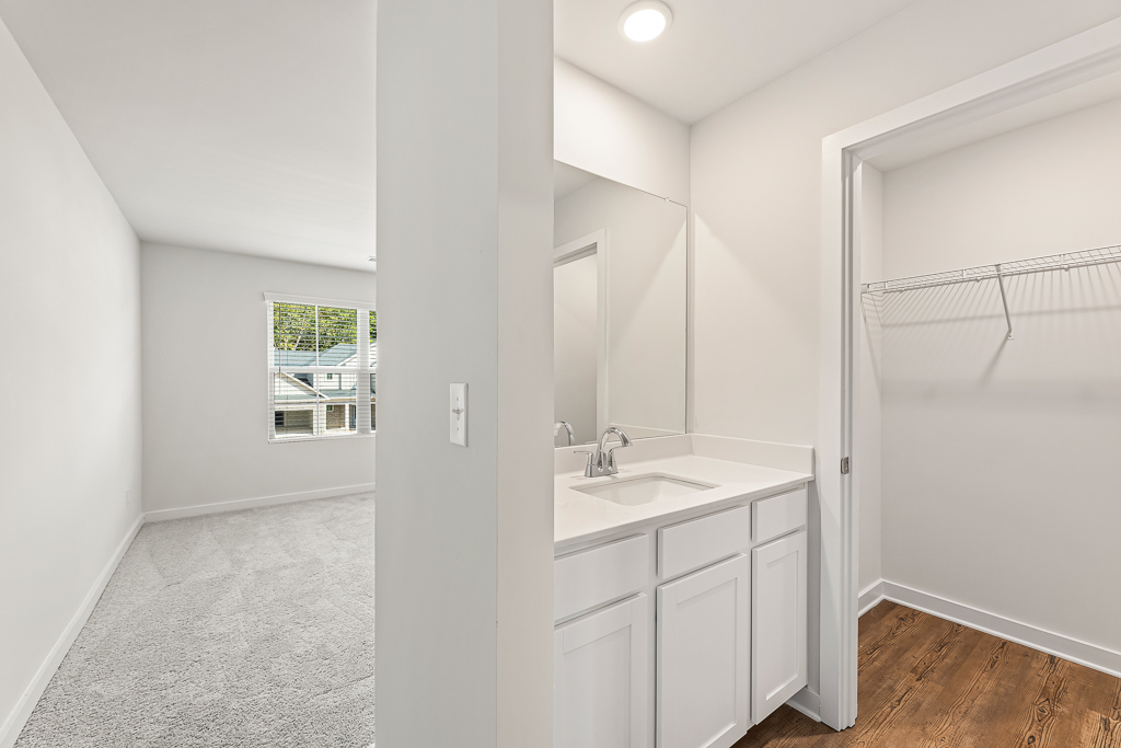 A bathroom with a sink and a shower unit.