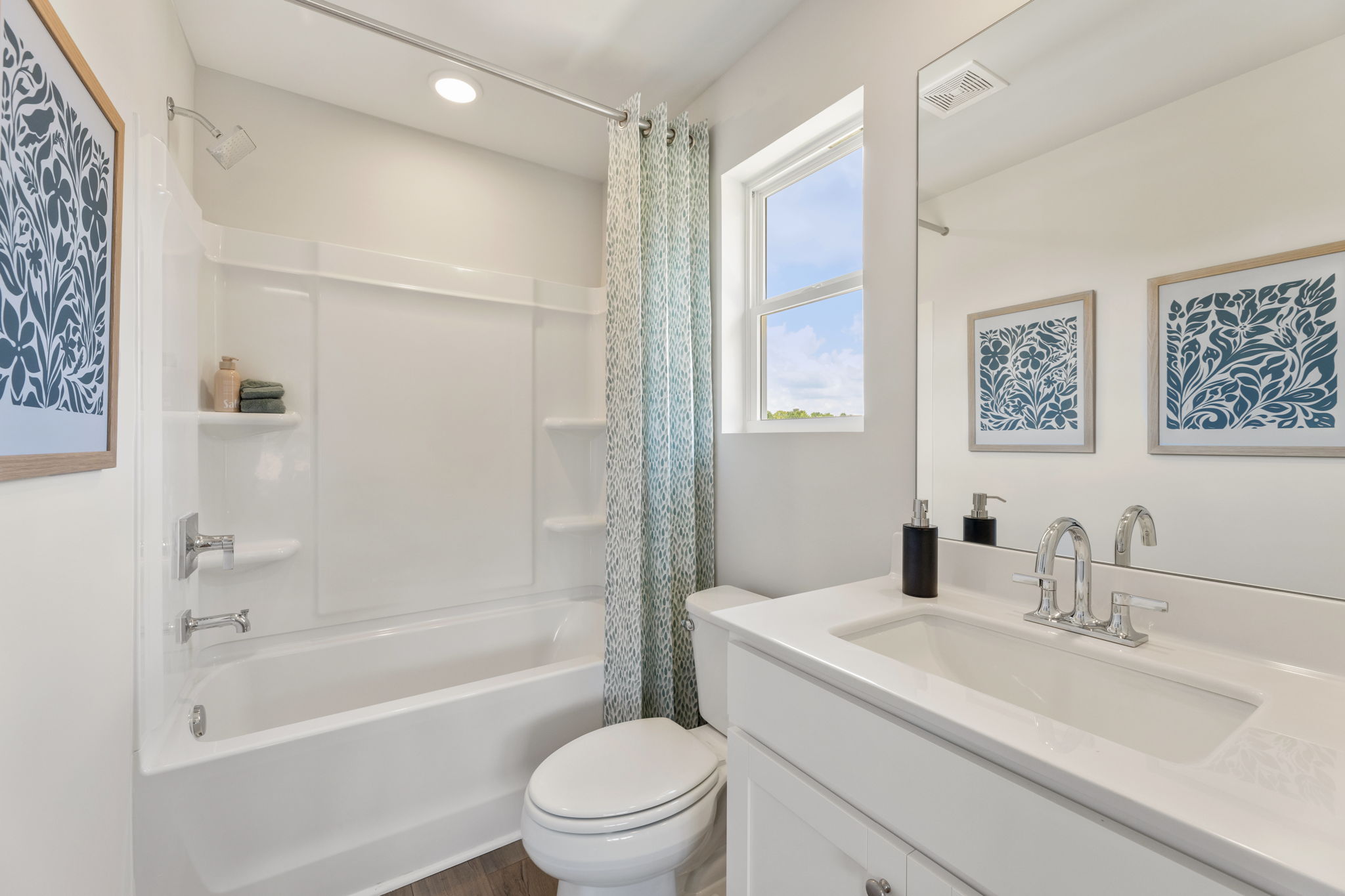 A bathroom with a tub sink and toilet.