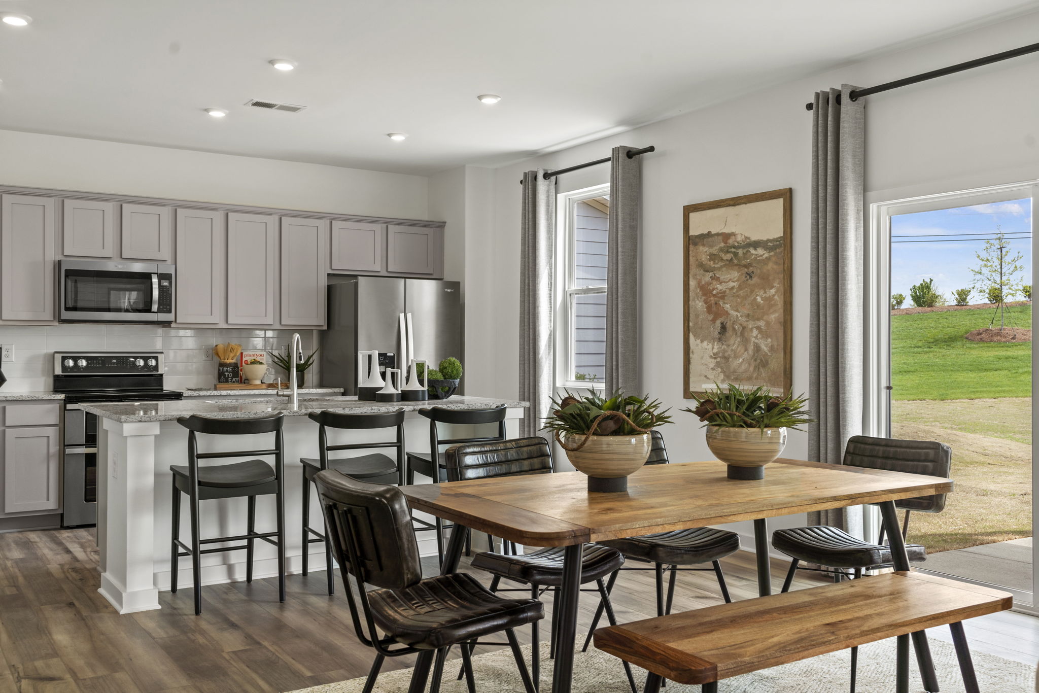 A kitchen with a table and chairs.