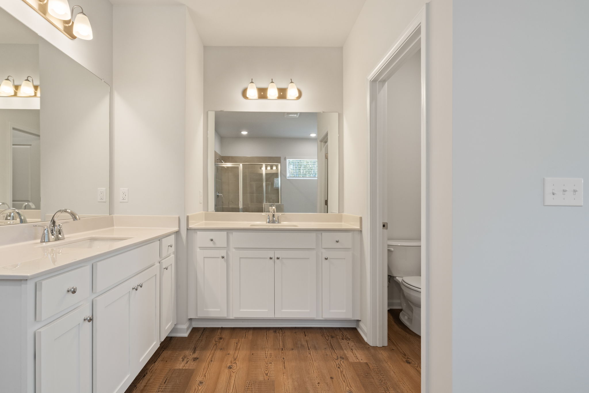 A bathroom with white cabinets.