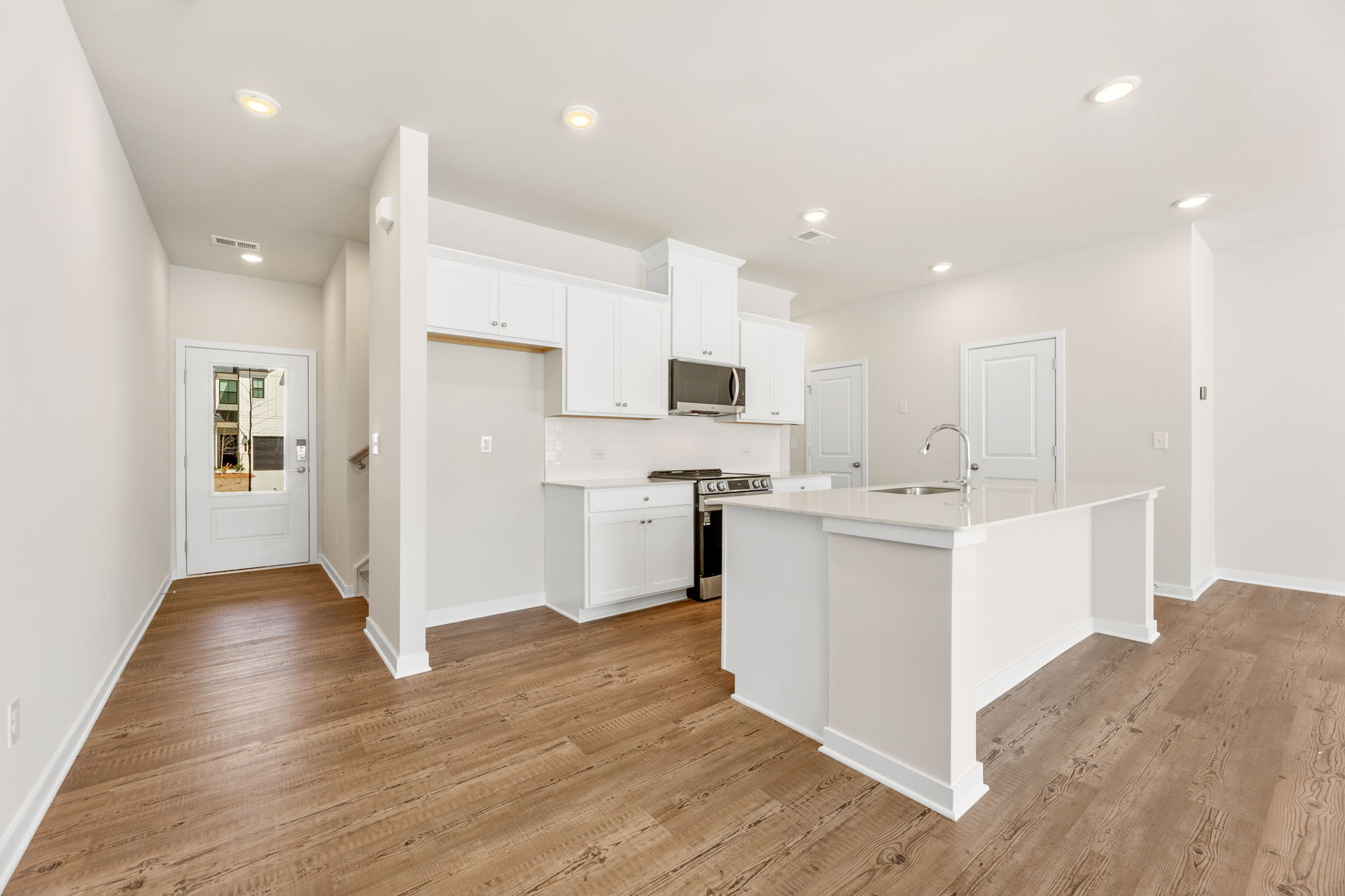 A kitchen with white cabinets.