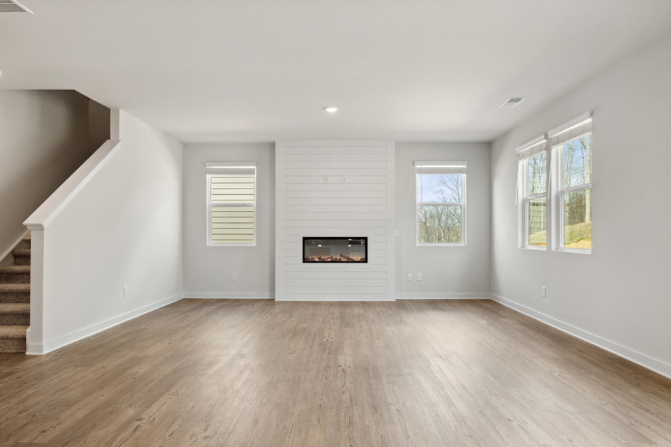 A room with a fireplace and windows.