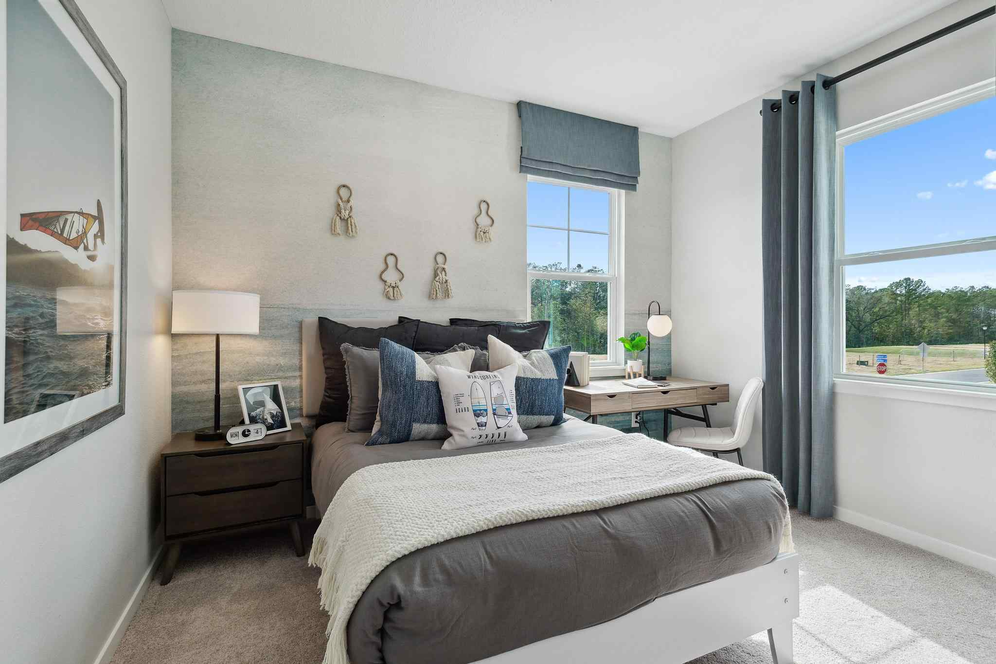 A bedroom with a bed and a window.