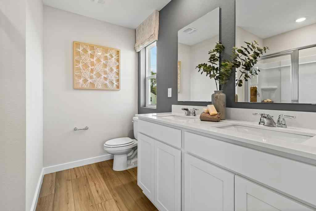 A bathroom with a large mirror.