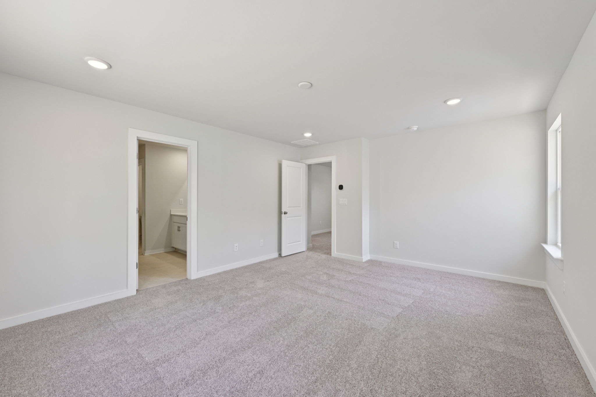 A long hallway with white walls.