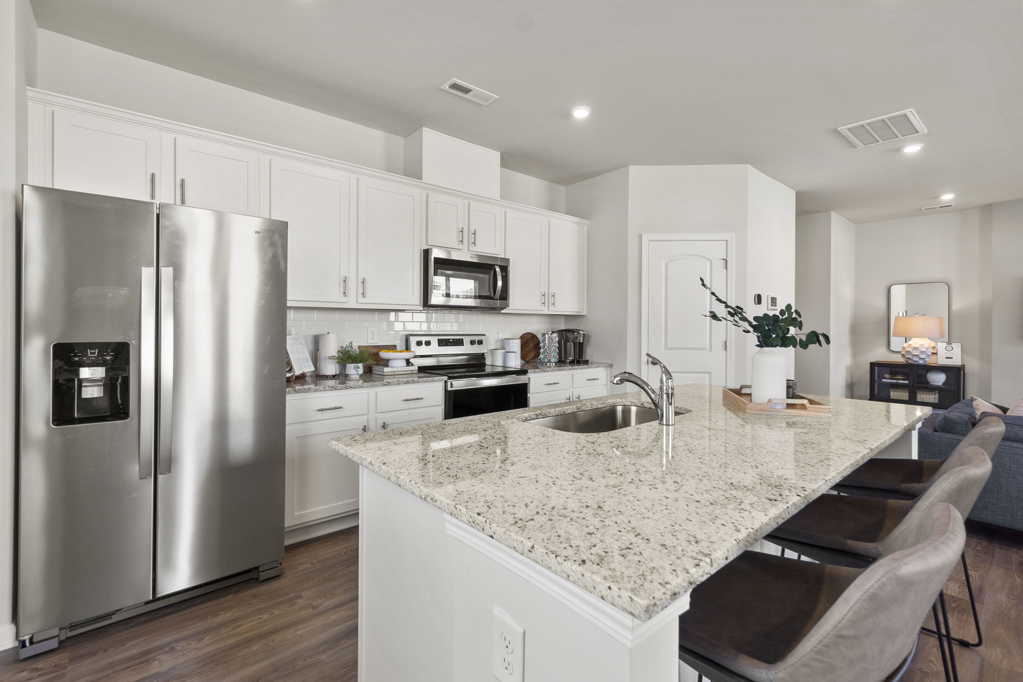 A kitchen with white cabinets.